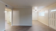 Located at 13751 Edwards St in Westminster, California, this single-story home offers a well-designed layout with consistent finishes throughout. The living areas feature durable wood-look vinyl flooring in a rich dark tone, crisp white crown molding, and neutral warm beige walls that create a clean, inviting atmosphere. Natural light filters in through window blinds across multiple rooms, enhancing the open feel of the space.

The kitchen is thoughtfully appointed with light wood cabinetry, dark granite-style countertops, and black appliances including a gas range and built-in microwave. A double sink sits beneath a window, and recessed lighting illuminates the workspace efficiently.

The bedrooms continue the wood-look flooring and are each equipped with ceiling fans and ample natural light. One bedroom features mirrored sliding closet doors, adding a sense of depth and additional reflective light. An additional room with built-in wood cabinetry provides versatile storage or display space.

The bathroom includes a tub and shower combination enclosed by sliding glass doors, a pedestal sink, and wood-look flooring that ties cohesively to the rest of the home.

Crown molding and ceiling fans are present in the main living areas, further contributing to the home's polished, comfortable character throughout.
