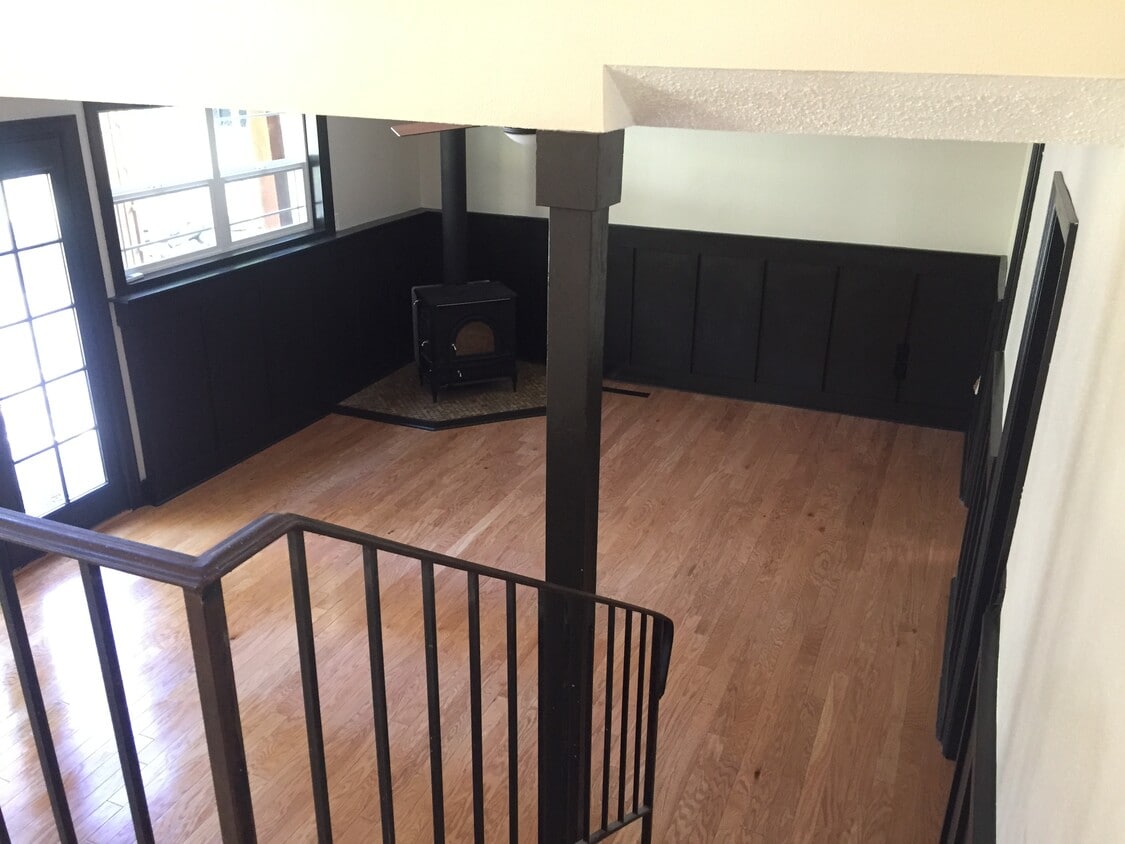 Sunken living room with woodstove and french doors out to patio - 8514 41st St W