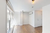 Located at 4350 Avenue De L'Hôtel-De-Ville in Montreal's vibrant Plateau-Mont-Royal neighbourhood, this efficiently designed single-floor unit makes excellent use of its compact footprint. Rich, dark hardwood flooring runs throughout the living areas, lending warmth and character to the bright, white-walled interior.

The kitchen is a functional highlight, featuring sleek grey cabinetry that extends to the ceiling for ample storage, a stainless steel refrigerator, dishwasher, and stove, complemented by a clean white countertop and a track lighting fixture overhead. The layout maximizes every inch of available space without sacrificing style.

The main living area benefits from natural light streaming through a large double-hung window, fitted with a baseboard heater beneath — a practical detail suited to Montreal's climate. The clean white walls and simple globe ceiling fixture keep the atmosphere open and airy.

The bathroom is finished with beige ceramic tile flooring and includes a soaking tub with shower, toilet, and vanity mirror. A dedicated laundry area houses a stacked front-loading washer and dryer set, adding a valuable in-unit convenience. Overall, the space presents a clean, modern aesthetic with practical amenities thoughtfully integrated throughout.