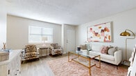 This two-story residence offers two bedrooms and two bathrooms across a thoughtfully arranged floor plan. The living room serves as the heart of the home, featuring light wood-style flooring, a textured ceiling, and a large window that brings in natural light, creating a warm and inviting atmosphere. Neutral wall tones provide a versatile backdrop throughout the space.

Adjacent to the living area, the dining space is defined by a pendant light fixture overhead and a sliding glass door dressed with vertical blinds, allowing for additional natural light and outdoor access. The galley-style kitchen features white cabinetry, light countertops, a double sink, and black appliances, offering an efficient and clean workspace.

Both bedrooms are carpeted and include ceiling fans for comfort. Each room is well-proportioned with windows that allow natural light to filter in. One bedroom connects to a flex area that can accommodate a home office setup. Soft, neutral tones carry throughout the sleeping quarters, contributing to a calm and restful environment. Overall, the residence presents a clean, functional, and cohesive design.