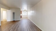 Located at 1500 Pine St in Concord, CA, this one-bedroom, one-bathroom unit offers a practical and well-organized single-floor layout. Light-toned wood-style flooring runs throughout, creating a cohesive and easy-to-maintain interior.

The living room is an open, bright space featuring a ceiling fan and large sliding glass doors fitted with vertical blinds, which open to a private outdoor patio area with mature greenery — providing natural light and a connection to the outdoors. A wall-mounted air conditioning unit ensures year-round comfort.

The combined dining room and kitchen is defined by a structural dividing column, with rich mahogany-toned upper cabinetry, a white refrigerator, and a white range providing functional appliances in a compact arrangement. A ceiling fan with light fixture adds airflow to the space.

The bedroom is a comfortable, well-lit room with a large window offering views of surrounding foliage, neutral walls, and a sliding-door closet offering convenient storage. An additional closet is accessible via the hallway.

The bathroom is clean and bright, featuring a white vanity with under-cabinet storage, a rectangular wall mirror with overhead lighting, and light-toned tile flooring. A hallway connects all rooms efficiently, completing this thoughtfully laid-out home.