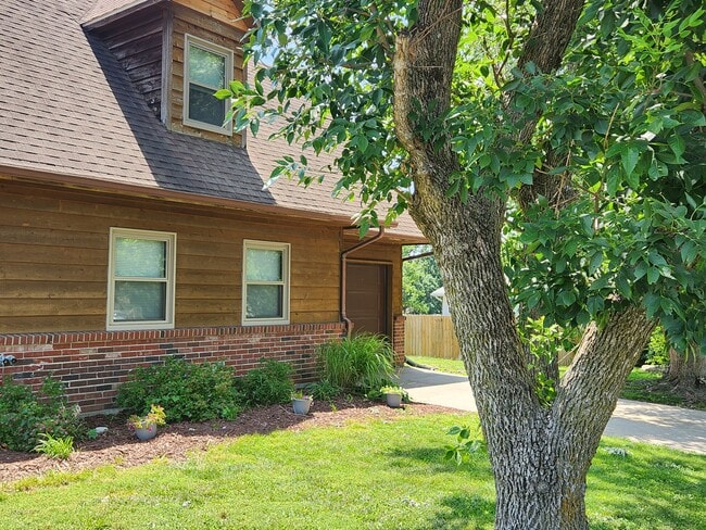 cedar and brick exterior - 4304 E Santa Anna Dr