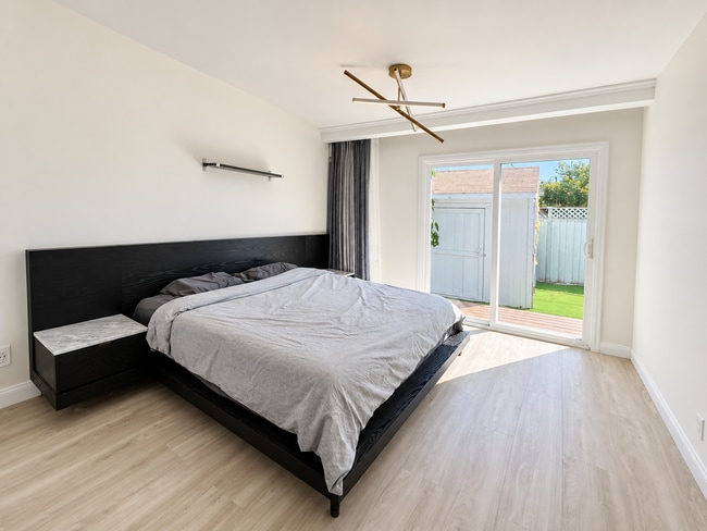 Spacious primary bedroom with direct backyard access. - 826 San Pablo Ave
