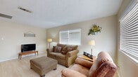Located at 1604 W Cherry Ave in Orange, Texas, this single-story 2-bedroom, 1-bathroom home offers a practical and comfortable layout designed for easy everyday living. The living room serves as the heart of the home, featuring light wood-tone flooring, a textured ceiling, and multiple windows with white blinds that allow generous natural light to fill the space. The open flow connects the living area to a dedicated dining space, making the layout ideal for both relaxing and entertaining. The kitchen is equipped with white cabinetry, granite-style countertops, a tile backsplash, and tile flooring, providing ample storage and counter space for meal preparation. Both bedrooms are well-sized, each featuring light wood-tone flooring, ceiling fans, and windows dressed with blinds and curtains that offer privacy while maintaining brightness. The full bathroom includes a white vanity with sink, a toilet, and a tub-shower combination. Neutral warm tones are used consistently throughout the home, creating a cohesive and inviting atmosphere. The straightforward single-floor layout ensures accessibility and ease of movement throughout the residence, making this home a functional and welcoming space in Orange, TX.
