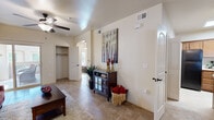 Located in Artesia, New Mexico, this well-appointed single-story, one-bedroom, one-bathroom home offers a functional and cohesive layout designed for comfortable living. Warm-toned tile flooring runs throughout the main living areas, complemented by neutral walls that lend a bright, welcoming atmosphere.

The living room features a ceiling fan overhead and a sliding glass door that opens to a private patio, filling the space with natural light. A dedicated hallway closet provides convenient storage just off the living area. The separate dining room includes a window with blinds and offers an intimate setting for meals.

The kitchen is equipped with warm wood cabinetry, black appliances including an electric range and refrigerator, a stainless steel sink, and ample counter space. A notable feature is the in-unit laundry closet adjacent to the kitchen, housing a full-size washer and dryer.

The bedroom is a comfortable retreat with light wood-toned flooring, a ceiling fan, and a window that allows natural light to pour in. The full bathroom features tile surround, a tub-shower combination, a wood-toned vanity with countertop storage, and tile flooring.

An arched entryway and clean architectural lines throughout add a subtle elegance to this efficiently designed home.