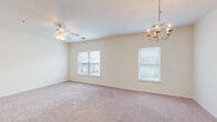Located at 1000 Channel Marker Way in Hanahan, South Carolina, this single-story 2-bedroom, 2-bathroom residence offers a practical and comfortable layout with well-appointed finishes throughout. The open-concept living and dining area is generously sized, featuring soft carpeting, a ceiling fan, a decorative chandelier, and multiple windows that allow natural light to fill the space with a bright, airy feel.

The kitchen is equipped with rich dark-stained cabinetry, granite-style countertops, a curved peninsula for additional prep space and casual dining, and a full suite of black appliances including a range, microwave, dishwasher, and refrigerator. Light wood-style flooring adds a clean, modern contrast to the darker cabinetry.

Both bedrooms are carpeted and include ceiling fans and windows with natural views. The spacious primary bedroom offers ample room and includes a dedicated closet. The bathrooms feature wood-style vinyl flooring, dark vanity cabinetry with countertops, and a tub-shower combination. A utility room provides added convenience and storage. With a neutral color palette, consistent finishes, and a thoughtfully designed floor plan, this residence offers a comfortable and functional living environment.