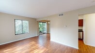 Located at 3512 Burton Ridge Rd SE in Grand Rapids, Michigan, this two-floor home offers a well-organized layout with a blend of hardwood and carpeted flooring throughout. The main living area is spacious and filled with natural light, courtesy of large windows fitted with vertical blinds and a sliding glass door that opens to a view of lush greenery. The open flow between the living and dining areas is accented by warm hardwood floors and a decorative pendant light fixture overhead.

The kitchen is efficiently designed, featuring rich wood cabinetry, dark countertops, and a full suite of stainless steel appliances including a refrigerator, range, microwave, and dishwasher. Hardwood flooring continues through this space, complementing the cabinetry tones.

The entry level also includes a foyer with a staircase leading to the upper floor, where the bedrooms are located. Each bedroom is carpeted, offering a quieter, softer environment, and includes windows that bring in natural light. At least one bedroom features a louvered bi-fold closet door, providing practical storage. The bathroom is clean and straightforward, equipped with a single-sink vanity, a tub-shower combination with a curved curtain rod, and tile flooring.