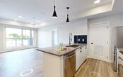 This well-appointed 2-bedroom, 2-bathroom unit at 10119 85 Ave NW offers a thoughtfully designed open-concept layout finished with modern details throughout. Light-toned luxury vinyl plank flooring flows seamlessly across the entire space, complementing the clean white walls and creating a bright, cohesive aesthetic.

The kitchen serves as the centerpiece of the living area, featuring white cabinetry, quartz countertops, a navy tile backsplash, and a full suite of stainless steel appliances including a range, microwave, and refrigerator. A central island with a built-in sink and pendant lighting overhead adds both functionality and style, opening directly to the living area.

Both bedrooms are generously proportioned with large windows that frame views of the surrounding urban landscape, filling each room with natural light. The primary bedroom benefits from its own dedicated closet and private ensuite bathroom, which features a glass-enclosed shower, a vessel sink vanity with matte black fixtures, and contemporary tile flooring. The second bathroom offers a full soaker tub framed by large-format neutral tiles, providing a clean and relaxing retreat.

Two closets provide ample storage throughout the unit. The overall design balances modern minimalism with warm, functional elements, making this a comfortable and visually appealing space.