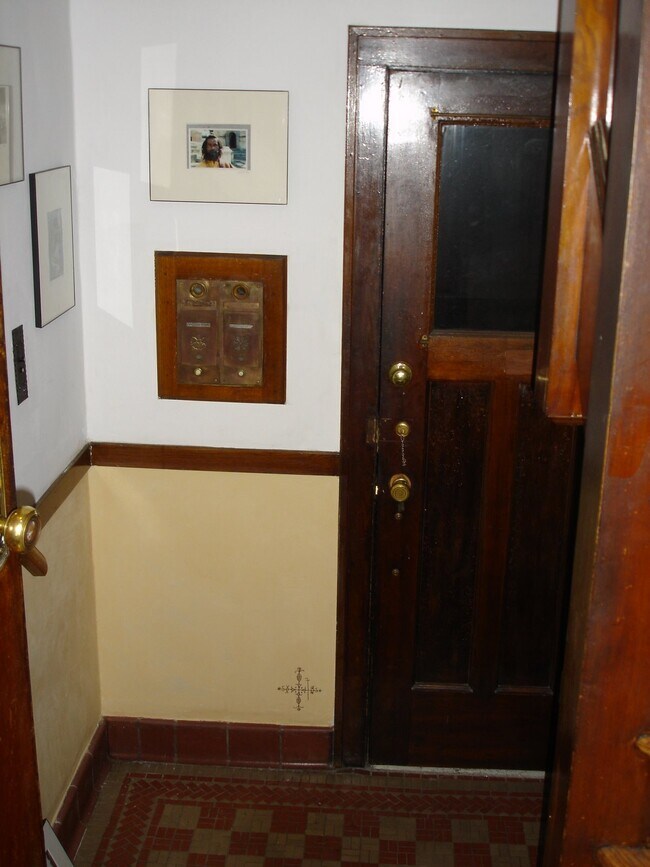 The front steps lead to a shared entryway. Interior view of front door. - 1407 Monroe St