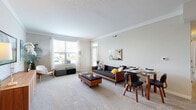 Located at 7027 Park Mill Drive in Plain City, Ohio, this single-floor, three-bedroom, one-bathroom home offers a well-designed layout across a comfortable footprint. The open-concept living and dining area is bright and welcoming, featuring plush carpeting, crown molding, and large windows that flood the space with natural light and offer views of the surrounding neighborhood. A glass-paneled entry door adds additional light to the living area.

The kitchen is a functional highlight, outfitted with dark cabinetry, granite-style countertops, stainless steel appliances including a range, microwave, and refrigerator, and warm hardwood-style flooring. A central island with pendant lighting and bar seating makes it ideal for casual dining or entertaining.

The primary bedroom is a spacious retreat featuring soft carpeting, a cool blue accent wall, and generous proportions. The two additional bedrooms offer flexible use, with one configured as a home office, each benefiting from natural light and carpeted floors. Each bedroom includes its own closet.

The bathroom continues the home's cohesive aesthetic with dark cabinetry, granite countertops, and hardwood-style flooring. A dedicated laundry area adds everyday convenience. Throughout, the home maintains a clean, neutral palette with modern finishes.