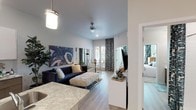 Located at 2177 E Apache Blvd in Tempe, Arizona, this single-floor residence offers a thoughtfully designed layout with modern finishes and a bright, welcoming ambiance. The open-concept living area is anchored by light hardwood-style flooring, elevated ceilings with a ceiling fan, and a pendant light fixture that adds a warm glow. Large patio doors invite natural light and lead to an outdoor space, while a navy velvet sofa and bold wall art create a sophisticated yet comfortable atmosphere. The kitchen is a galley-style space outfitted with two-tone cabinetry in walnut and white, light granite countertops, stainless steel appliances, and under-cabinet lighting. A dedicated laundry closet with a stacked washer and dryer is conveniently positioned nearby. The bedroom is generously sized with plush carpeting, high ceilings, and large windows dressed in bold floral curtains that fill the room with natural light. A walk-in closet provides ample storage. The bathroom features a warm walnut vanity and clean, neutral finishes, with light hardwood-style flooring extending into the hallway. Overall, the space blends contemporary design with functional living in a well-connected Tempe location.