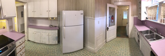 Kitchen with fridge, dishwasher, upgraded range and laundry room - 1002 Turner St