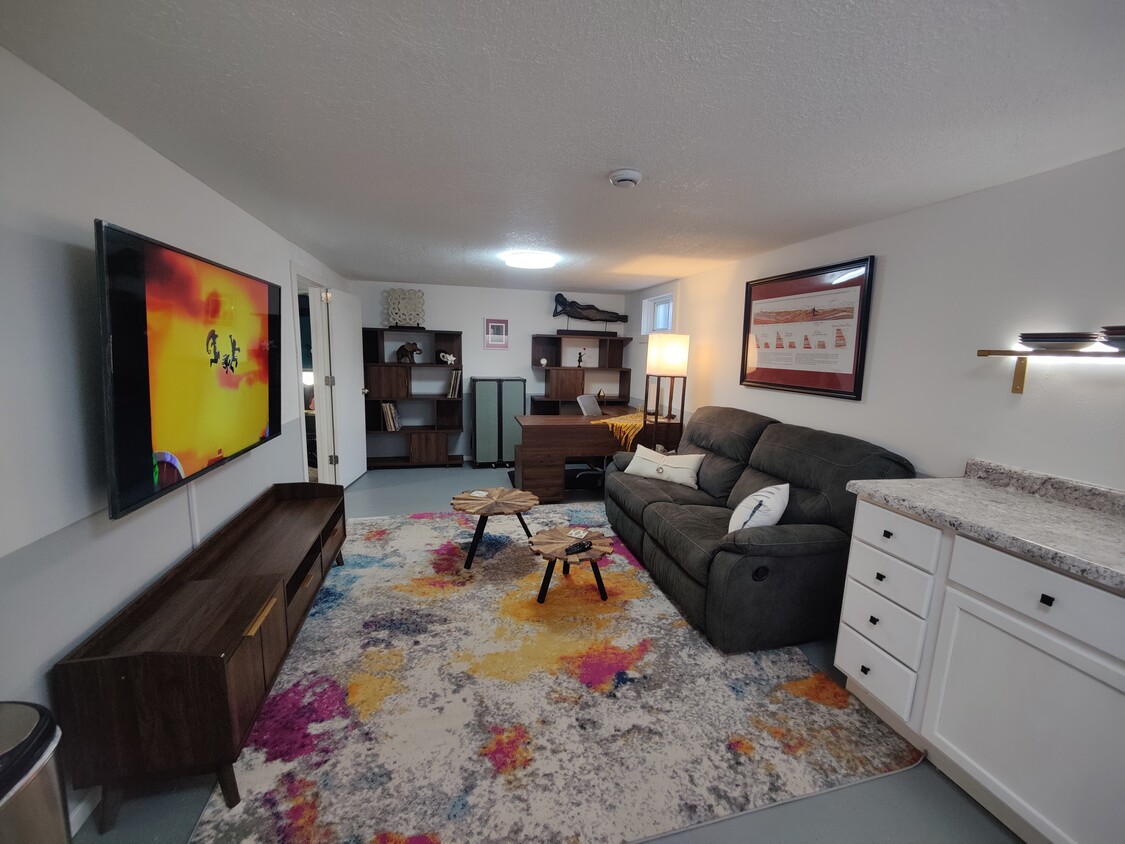 Combination living room/office with reclining sofa, 65" smart TV, and direct wired ethernet at the d - 2913 Clover St