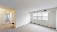 Located at 260 Christiana Rd in New Castle, Delaware, this single-floor unit offers three bedrooms, two bathrooms, a kitchen, and a closet arranged in a practical, well-organized layout. The interior is finished in a clean, neutral palette of white walls and light-toned carpeting throughout the living and bedroom areas, creating a bright and cohesive atmosphere.

The spacious primary bedroom is notably generous in size, featuring large windows with blinds that allow ample natural light and a direct connection to one of the two bathrooms. The additional bedrooms are well-proportioned and carpeted, maintaining the same clean aesthetic. Each room benefits from white walls and ceiling vents for climate control.

The kitchen is equipped with rich, dark-stained cabinetry, laminate countertops, and white appliances including a coil-burner range, dishwasher, and full-size refrigerator, offering a functional and efficient cooking space.

The two bathrooms feature wood-look flooring, clean white fixtures, and a sliding glass-enclosed shower in one, complemented by a vanity with dark cabinetry. A hallway connects the rooms, offering a straightforward flow throughout the unit. Overall, the space presents a tidy, move-in ready environment with practical finishes suited for comfortable everyday living.