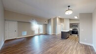 Located at 1166 Boone Aire Rd in Florence, Kentucky, this 2-bedroom, 2-bathroom residence offers a thoughtfully designed single-floor layout. The open-concept kitchen and living area serves as the heart of the home, featuring rich wood-look flooring, vaulted ceilings that add a sense of height and openness, and a central island with a clean white countertop and dark cabinetry. The kitchen is equipped with stainless steel appliances, including a refrigerator, range, microwave, and dishwasher, complemented by dark espresso-toned cabinetry and a dedicated pantry. French doors lead to a private balcony, filling the living space with natural light. Both bedrooms feature plush carpeting and generous closet space — five closets in total throughout the home ensure abundant storage. The bathrooms are finished with clean white tile surrounds and tub-shower combinations. Neutral warm-toned walls throughout create a cohesive, inviting ambiance. A hallway connects the private quarters to the main living area, providing a clear and functional flow. This residence combines modern finishes with practical design for comfortable everyday living.