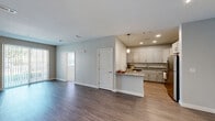 Located at 100 Flint Pond Cir in Shrewsbury, MA, this 2-bedroom, 2-bathroom unit offers a well-designed single-floor layout that efficiently utilizes its comfortable footprint. The open-concept kitchen and living area serves as the heart of the home, where the kitchen stands out with white shaker-style cabinetry, granite countertops, stainless steel appliances including a range, microwave, dishwasher, and refrigerator, and light wood-style flooring. A peninsula provides additional counter space and casual seating. The living room extends naturally from the kitchen and features dark wood-style flooring, neutral gray walls, and a sliding glass door that fills the space with natural light and provides access to an outdoor area. Both bedrooms are carpeted and finished with soft gray walls. The primary bedroom benefits from multiple windows that invite ample natural light, while the second bedroom includes a window with outdoor views. The two bathrooms are well-appointed: one features a glass-enclosed shower with granite-topped vanity and tile flooring, while the second includes a tub/shower combination with classic subway tile surround. A dedicated closet adds practical storage to round out this clean, modern unit.