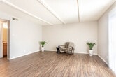Located at 2601 N A St in Midland, Texas, this two-story residence offers a well-organized layout designed for comfortable everyday living. The main living area features warm wood-look flooring, textured ceilings with decorative beam detailing, and a large sliding glass door dressed with vertical blinds that floods the space with natural light and provides outdoor access. A central staircase connects the two floors, as seen in the dollhouse overview.

The galley-style kitchen is efficiently arranged with warm wood cabinetry, granite-look countertops, and black appliances including a range, dishwasher, and refrigerator. A ceiling fan overhead and a window at the end of the corridor add airflow and light to the cooking space.

The bedrooms are carpeted for comfort and each feature ceiling fans with light fixtures. Windows allow natural light to filter in, creating a bright and airy atmosphere throughout.

The bathrooms are finished with wood-look flooring, warm wood vanity cabinetry, and granite-look countertops. The primary bathroom offers a spacious dual-sink vanity with a separate tiled tub and shower area, while a secondary half bath provides a convenient vanity and toilet. The consistent finishes throughout create a cohesive and practical interior.