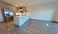 Step into a world of possibilities in this exquisitely designed apartment at Aura -219. The heart of this home is the gourmet kitchen, where culinary dreams come to life. Sleek stainless-steel appliances, including a built-in microwave and range, complement the crisp white cabinetry and subway tile backsplash, creating a space that's both functional and aesthetically pleasing.

The living area is a testament to modern luxury, featuring warm wood-look flooring and an abundance of natural light streaming through expansive windows. A sliding glass door leads to your private balcony, offering a serene outdoor retreat and picturesque views of the surrounding landscape.

The spacious bedroom, boasting 150 square feet, is a tranquil haven with plush carpeting and ample closet space. The bathroom exudes spa-like tranquility with its glass-enclosed shower, contemporary vanity, and elegant finishes.

Throughout the apartment, thoughtful details abound - from the stylish ceiling fan to the energy-efficient lighting. The open-concept layout creates a sense of spaciousness, perfect for entertaining or relaxing after a long day.

Located in the vibrant community of North Chesterfield, this home offers the perfect blend of urban convenience and suburban charm. Embrace a lifestyle of comfort, style, and endless possibilities in this meticulously crafted living space. Your journey to inspired living starts here at Aura -219.