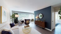 This thoughtfully designed single-floor residence combines modern style with functional living across a well-organized layout. The open-plan living and dining area serves as the heart of the home, featuring warm hardwood-style flooring, a striking deep navy accent wall with a round mirror and wood credenza, and large windows fitted with blinds that bathe the space in natural light. The dining area flows seamlessly from the living room, offering views of lush greenery outside. The kitchen is outfitted with rich dark-wood cabinetry, granite countertops, a subway tile backsplash, a stainless steel gas range, and an under-mount sink — delivering a polished, functional cooking space. Two well-proportioned bedrooms provide peaceful retreats, each featuring wide windows with outdoor tree views, hardwood-style flooring, and ample natural light; one bedroom includes a ceiling fan for added comfort. The bathroom features classic white tile with black accents, a pedestal sink with chrome fixtures, a tub-shower combination, and a large illuminated mirror with a built-in ledge for storage. A light-toned entryway with clean lines and indoor greenery completes the space, offering a welcoming transition throughout the home.