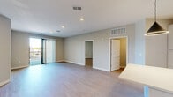 This single-floor residence at 2120 NW Lowenstein Dr in Lee's Summit, Missouri offers a clean, contemporary design with an open and airy floor plan. Light-toned luxury vinyl plank flooring flows throughout, complementing the neutral gray and beige color palette that lends a bright, cohesive feel to every room.

The kitchen is a standout feature, showcasing tall white shaker cabinetry, light quartz countertops, a large center island, and a full suite of stainless steel appliances including a range, microwave, dishwasher, and French door refrigerator. A bold geometric pendant light adds a modern focal point above the island.

The open living area is generously proportioned, with recessed lighting overhead and sliding glass doors that lead to a private balcony overlooking the surrounding neighborhood. Natural light fills the space throughout the day.

The bedrooms are well-sized, each featuring neutral tones, ceiling fans, and large windows. Each bedroom benefits from direct access to a walk-in closet and a private bathroom. The primary bath impresses with a dual-sink vanity topped with quartz counters, white cabinetry, and brushed nickel fixtures paired with an expansive mirror.

Overall, this residence combines modern finishes with functional design, creating a comfortable and stylish living environment.