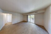 Located at 2951 Pheasant Run Dr in Jackson, Michigan, this 2-bedroom, 1-bathroom unit offers a practical and comfortable single-floor layout. The open living area is carpeted throughout and filled with natural light, courtesy of sliding glass doors that lead to a private balcony overlooking outdoor greenery. A tiled entryway with a solid wood front door welcomes residents into the space.

The galley-style kitchen is well-appointed with warm oak cabinetry, light granite-style countertops, a double-basin sink, and white appliances including a coil-top range and refrigerator. A pantry closet adjacent to the kitchen provides convenient additional storage.

Both bedrooms are carpeted and bright, each featuring vertical blind-covered windows that allow ample natural light. The primary bedroom includes a sliding closet for storage. A hallway connects the main living areas to the bedrooms and the full bathroom, which features a tub-shower combination with tile surround, a vanity with under-sink storage, a medicine cabinet mirror, and stone-look tile flooring.

A dedicated closet in the hallway offers further storage. The neutral color palette and straightforward layout make this unit a functional and move-in-ready space in the Pheasant Run community.