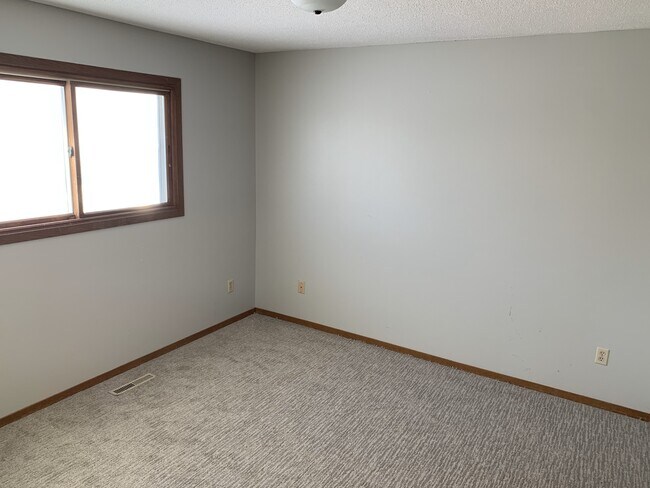 Spacious second-floor bedrooms with brand-new carpet and large windows offering natural light and st - 4903 W Kirkwood Cir
