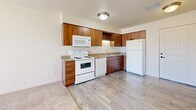 Located at 3500 S Sherman St in Englewood, Colorado, this one-bedroom, one-bathroom residence offers a thoughtfully organized single-floor layout that makes excellent use of its compact footprint. The open-concept living and kitchen area is bright and welcoming, with light-toned walls, plank-style flooring, and a sliding glass door that leads to a private balcony, allowing natural light to fill the space. Vertical blinds provide adjustable privacy throughout.

The kitchen is well-equipped with warm wood-toned cabinetry offering generous upper and lower storage, a double-basin sink, and a full suite of white appliances including a range, dishwasher, microwave, and refrigerator. The transition from kitchen to living area is seamless, with hard-surface flooring giving way to plush carpet.

The bedroom is a comfortable, carpeted retreat with a natural light window and a sliding-door closet, complemented by two additional closets elsewhere in the unit for exceptional storage capacity. The bathroom features wood-toned cabinetry, light plank flooring, and accessibility-friendly grab bars. A dedicated laundry area adds everyday convenience. Neutral tones and clean finishes throughout create a calm, functional living environment.
