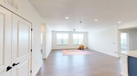 Located at 3515 Manor Rd in Austin, TX, this well-designed 3-bedroom, 2-bathroom single-story home offers a clean, modern aesthetic with thoughtful finishes throughout. Light wood-tone flooring flows seamlessly across all rooms, creating a cohesive and airy feel.

The kitchen is a standout feature, showcasing striking two-tone cabinetry with bold blue lower cabinets and crisp white upper cabinets, all topped with granite countertops. A large central island with pendant lighting provides ample workspace and casual dining. Stainless steel appliances, including a refrigerator, range, and microwave, complete this functional and stylish space.

The living room is generously proportioned, featuring a ceiling fan and dual windows that invite natural light and offer views of the surrounding greenery. Each of the three bedrooms is well-sized, with the spacious primary bedroom offering comfortable room for a full furniture arrangement. The secondary bedrooms also feature ceiling fans and windows with outdoor views.

Both bathrooms are finished with navy cabinetry, granite vanity tops, and light flooring. One bathroom includes a tub/shower combo with built-in shelving, while the second features a walk-in shower and additional open shelving. Three closets provide practical storage throughout the home.