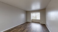 Located at 834 Timberlake Ct in Arlington, TX, this one-bedroom, one-bathroom unit offers a practical and comfortable single-floor layout. The living room makes a strong first impression with rich, dark hardwood-style flooring, neutral gray walls, a textured ceiling, and a window fitted with blinds that allows natural light to fill the space.

The kitchen is thoughtfully appointed with gray cabinetry, light stone-look countertops, a mosaic tile backsplash, a double-basin sink, and black appliances — including a refrigerator and stove — all set atop matching hardwood-style flooring, creating a cohesive aesthetic.

The bedroom is carpeted for warmth and comfort, features a ceiling fan with light fixture, a window with blinds for natural light, and is connected to a hallway via a paneled door. Two closets provide ample storage throughout the unit.

The bathroom includes a full tub-shower combination with white square tile surround, maintaining a clean and functional design.

A connecting hallway ties the rooms together efficiently. Throughout the unit, neutral tones and consistent finishes create a unified, move-in-ready atmosphere well-suited for comfortable everyday living in the heart of Arlington, Texas.