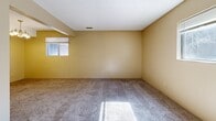 Located at 3280 Raven Oaks Dr in Dubuque, Iowa, this two-bedroom, one-bathroom residence offers a practical and efficient single-floor layout. The space features neutral, warm-toned walls throughout, complemented by plush carpeting in the bedroom areas that adds comfort underfoot.

The primary bedroom is generously sized, featuring a ceiling fan with light fixture, a window that brings in natural light, and a textured ceiling. The second bedroom is equally well-appointed, boasting two sets of sliding wood-paneled closet doors for ample storage, a ceiling fan, and carpeted floors, with warm yellow-toned walls giving the room a cozy feel.

The kitchen is a functional galley-style space lined with warm wood cabinetry, light granite-style countertops, and tile flooring. It comes fully equipped with black appliances, including a refrigerator, electric range, dishwasher, and an over-range ventilation hood, providing everything needed for daily meal preparation.

The full bathroom includes a tub-shower combination with clean white surround, a toilet, and a vanity with storage, finished with tile flooring and neutral tan walls. A connecting hallway links the rooms cohesively, completing this well-organized and move-in ready residence.