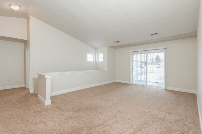 Spacious living area with a sliding glass door to the balcony (upper apartment) - Jordache Park Apartments