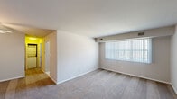 Located at 816 Lawrence Dr in Newark, Delaware, this single-floor residence features four bedrooms, one bathroom, a living room, and a kitchen within a compact, efficiently arranged floor plan. The living room is bright and open, with neutral-toned walls, wall-to-wall carpeting, and a large window fitted with vertical blinds that allows natural light to fill the space. Each bedroom continues the carpeted flooring theme and features neutral wall tones, creating a cohesive and understated aesthetic throughout. Several bedrooms include closets — one with mirrored sliding doors, another with a walk-in style closet with built-in shelving — and at least one room is equipped with a ceiling fan with integrated lighting. Windows in the bedrooms provide natural light and outdoor views. The kitchen is thoughtfully appointed with dark espresso cabinetry, light-toned countertops, tile flooring, and black appliances including a refrigerator, range, and dishwasher. A window above the sink adds natural light to the cooking area. The bathroom features tile flooring in warm earth tones, a bathtub with shower, and a vanity with dark cabinetry. The overall ambiance of the home is clean, neutral, and move-in ready.