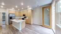 Located at 5129 Dowdell Ave in Rohnert Park, California, this two-story home offers a well-organized layout designed for comfortable everyday living. The kitchen serves as a central highlight, featuring light maple cabinetry extending to the ceiling, stainless steel appliances including a gas range, built-in microwave, and refrigerator, all anchored by a peninsula with a double sink and white countertops. Recessed lighting and wood-look flooring give the space a clean, contemporary feel. A glass-panel door provides additional natural light to the area.

The bedrooms are carpeted and well-proportioned, each receiving natural light through windows fitted with blinds. The bathrooms are thoughtfully appointed with light wood vanities, white countertops, large mirrors, wall sconces, and wood-look flooring. The primary bathroom features a double-sink vanity, offering ample counter space and storage.

A dedicated laundry room accommodates a full-size washer and dryer alongside upper cabinetry and a folding counter. The attached two-car garage features a paneled door with windows, an automatic opener, and a utility panel, providing generous storage and parking capacity throughout.