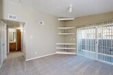 Located at 3597 S Zeno Way in Aurora, CO, this single-floor, 2-bedroom, 2-bathroom home offers a well-organized and functional layout. The open-concept living, dining, and kitchen area serves as the heart of the home, with soft carpet underfoot in the living space and a sliding glass door that fills the room with natural light and provides outdoor access. A set of built-in corner shelves adds a distinctive architectural detail, offering practical display and storage space. The kitchen features warm honey-toned wood cabinetry, a tiled mosaic backsplash, wood-look flooring, and black appliances including a refrigerator, range, and over-the-range microwave. Both bedrooms are carpeted and finished in neutral tones, offering comfortable, quiet retreats. The spacious primary bedroom includes a generous walk-in closet equipped with dual shelving systems for ample organization. The two bathrooms each feature wood-look tile flooring, a tub-shower combo with tiled surround, and warm wood vanity cabinetry with light countertops. Additional highlights include a dedicated laundry area, a utility room, a hallway connecting the main spaces, and four total closets throughout, ensuring excellent storage capacity across the entire home.