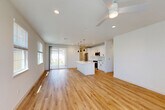 Located at 448 Denton Ave in Vacaville, California, this modern single-story home offers three bedrooms, three bathrooms, and a thoughtfully designed open-concept floor plan. Light-toned hardwood flooring flows seamlessly throughout the living areas, complemented by crisp white walls and recessed lighting that create a bright, airy atmosphere. Ceiling fans are present in the living room and bedrooms, enhancing year-round comfort.

The open-concept living, dining, and kitchen area serves as the heart of the home. The contemporary kitchen features white shaker cabinetry with matte black hardware, a classic subway tile backsplash, stainless steel appliances, and a striking white waterfall-edge island with pendant lighting overhead. A sliding glass door connects the main living area to the outdoors, filling the space with natural light.

Each bedroom is well-proportioned, with large windows that invite natural light and neighborhood views, ceiling fans, and dedicated closet space. The three bathrooms are finished in a clean, modern style, with one featuring a tiled tub-and-shower combination and white vanity cabinetry.

Additional highlights include a dedicated laundry area, an interior hallway connecting all rooms, and an attached garage with interior access. The home presents a fresh, move-in-ready aesthetic throughout.