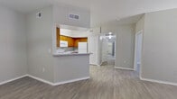 This single-story, 5-bedroom, 1-bathroom home offers a well-organized layout designed to maximize functionality. The living room serves as the heart of the home, featuring a classic white-mantled fireplace, a ceiling fan, and wood-look laminate flooring that extends throughout the space. Natural light filters in through windows and a glass door, creating a bright and welcoming atmosphere.

The kitchen is equipped with warm honey-toned wood cabinetry, a full suite of white appliances including a refrigerator, electric range, microwave, and dishwasher, complemented by granite-look countertops. A pass-through window connects the kitchen to the adjacent dining area, which features a pendant light fixture and easy access to the kitchen. Two hallways guide residents through the home's five bedrooms, each finished with the same durable wood-look flooring and neutral gray walls. Several bedrooms benefit from natural light through windows with blinds, while select rooms include access to closets — notably a spacious walk-in closet with built-in shelving and hanging rods. The full bathroom includes a single-sink vanity with wood cabinetry, granite-look countertop, and a tub/shower combination. Two additional closets provide generous storage throughout the home.