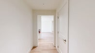 This thoughtfully designed 2-bedroom, 2-bathroom single-floor residence in Laurel, MD offers a clean, modern aesthetic with a cohesive neutral palette and light hardwood flooring throughout. The open-concept kitchen is a standout feature, boasting white shaker cabinetry, quartz countertops, a marble-style tile backsplash, stainless steel appliances, and a large central island — ideal for both cooking and entertaining. The adjacent living area is bright and airy, enhanced by recessed lighting and sliding glass doors that open to an outdoor view, filling the space with natural light. Both bedrooms are well-proportioned, each featuring windows with natural light, recessed lighting, and the same warm hardwood flooring. The primary bedroom offers a comfortable and private retreat. The two bathrooms are finished with white subway tile surrounds in the tub-shower combinations, light wood-look flooring, white vanities with quartz countertops, and brushed nickel hardware and fixtures. Connecting hallways provide smooth transitions between spaces, and a dedicated closet adds practical storage. The overall ambiance is fresh, modern, and move-in ready, reflecting quality finishes and attention to detail throughout.