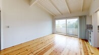 Located at 974 Haverford Ave in the desirable Pacific Palisades neighborhood of Los Angeles, this thoughtfully designed studio offers a compact yet efficient layout across a single floor. The living area immediately impresses with soaring vaulted ceilings accented by exposed white-painted wood beams, creating a sense of openness well beyond the unit's footprint. Warm, wide-plank hardwood floors run throughout, adding natural character and continuity to the space. Sliding glass doors in the living area open directly onto a private balcony, flooding the interior with natural light and offering pleasant views of the surrounding treetops and neighborhood. Two mirrored sliding-door closets provide ample storage while visually expanding the room. The kitchen is efficiently arranged with white cabinetry, tile countertops with a classic red accent trim, a stainless steel refrigerator, and a gas range, all set atop the same hardwood flooring. The bathroom features floor-to-ceiling white tile in the tub and shower enclosure, a wood-toned vanity, and a clean, bright finish. The overall ambiance is airy and light-filled, with a clean, minimalist aesthetic complemented by the warm tones of the natural wood floors throughout.