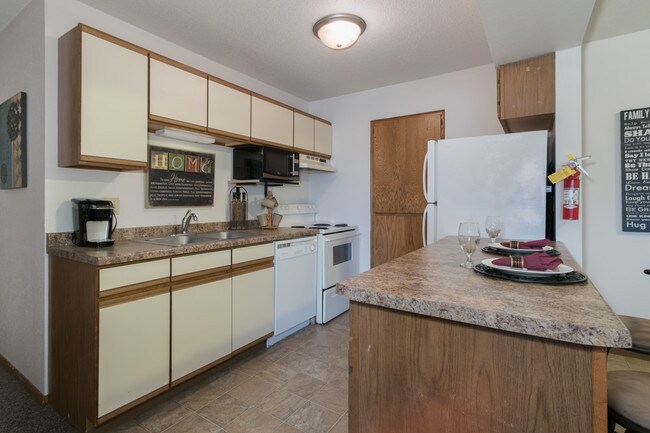 Kitchen - range rfg, mircrowave, dishwaher, & pantry - CHARLAMAIN - Exceptional Living By SCSU