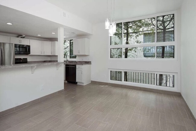 Dining area is open to living room and kitchen. - 10315 Missouri Ave