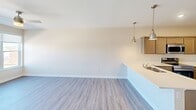 This 690 square foot apartment in Cedar Rapids, Iowa, offers a well-designed living space with modern amenities. The single-floor layout comprises one bedroom, one bathroom, and an open-concept kitchen and living area. The kitchen is a standout feature, boasting light-colored cabinetry, stainless steel appliances, and ample counter space. The living room seamlessly connects to the kitchen, creating an ideal space for entertaining or relaxing.

The bedroom, measuring 130 square feet, provides a cozy retreat with plush carpeting and a large window that allows natural light to flood the space. The bathroom is efficiently designed with a single vanity, toilet, and a shower/tub combination. A notable convenience is the in-unit laundry area, equipped with a stacked washer and dryer set and additional storage space.

Throughout the apartment, you'll find a harmonious blend of materials, including wood-look flooring in the main living areas and neutral-toned walls that create a bright, airy ambiance. The apartment also features modern touches such as recessed lighting and a sleek ceiling fan in the bedroom. Large windows in the living area and bedroom offer views of the surrounding cityscape, enhancing the overall living experience in this compact yet functional urban dwelling.