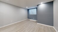 Located at 2572 Lenox Rd NE in Atlanta's 30324 zip code, this thoughtfully designed one-bedroom, one-bathroom unit offers a clean, modern aesthetic with quality finishes throughout. Light-toned luxury vinyl plank flooring flows seamlessly across every room, creating a cohesive and airy feel.

The open-concept living and dining area features recessed lighting, neutral gray walls, and a bold navy accent wall that adds a distinctive design touch. Windows fitted with horizontal blinds bring in natural light while maintaining privacy.

The kitchen is a standout, outfitted with gray shaker-style cabinetry, granite countertops, a herringbone-patterned tile backsplash, and a full suite of stainless steel appliances including a refrigerator, range, microwave, and dishwasher — combining both style and functionality.

The spacious primary bedroom features recessed lighting, a ceiling fan with a brushed gold fixture, a window for natural light, and ample wall space for flexible furniture arrangements.

The bathroom is cleanly finished with crisp white subway tile surrounding a soaking tub and shower combo, complemented by matte black fixtures for a contemporary contrast. Additional spaces include a hallway, utility room, and an unclassified flex room, rounding out this efficiently designed and move-in-ready Atlanta unit.