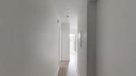 Located at 4900 Chemin de la Côte-des-Neiges in Montréal's Côte-des-Neiges neighbourhood, this thoughtfully designed 2-bedroom, 1-bathroom unit showcases a clean, modern aesthetic throughout its single floor. Light hardwood flooring runs consistently through all rooms, complemented by crisp white walls and bold black accents that lend the space a contemporary, cohesive character.

The kitchen is a standout feature, offering a peninsula with a striking black and white marble-patterned countertop, white upper and lower cabinetry extending to the ceiling, a matching backsplash, and stainless steel appliances including a French door refrigerator, stove, and built-in microwave.

The primary bedroom offers a comfortable footprint and includes a floor-to-ceiling built-in wardrobe with sleek white panels, paired with a bold black interior door. The second bedroom features a mirrored sliding closet with black framing and a window overlooking greenery, allowing natural light to fill the room.

The bathroom is elegantly finished with large-format marble-look porcelain tiles on both the floor and walls, a soaker tub with an overhead rain showerhead enclosed by a black-framed sliding glass door, a wood-toned vanity with a dark countertop, and a window for natural ventilation.

Black-framed windows throughout the unit reinforce the modern design language while bringing in natural light and views of the surrounding neighbourhood.