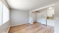 Located at 2909 Marconi Ave in the Arden-Arcade neighborhood of Sacramento, CA, this one-bedroom, one-bathroom unit offers a clean and functional layout across a single floor. Light wood-tone flooring runs throughout, lending a bright, cohesive feel to the entire space.

The open living area flows naturally into the kitchen zone, separated by a partial wall with a built-in shelving unit that provides both visual interest and additional storage. A ceiling fan overhead adds practical comfort. The kitchen is outfitted with white cabinetry, a tile backsplash, a gas range, and a full-size refrigerator, making efficient use of the available space.

The bedroom is a comfortable, well-proportioned room featuring a ceiling fan with light, a window with vertical blinds for natural light and privacy, and direct access to a dedicated closet. The neutral gray walls and wood flooring create a calm, restful atmosphere.

The bathroom features a shower-tub combination with chrome fixtures, a toilet, and a towel bar, finished with classic pink tile flooring and blue tile accents at the baseboard—adding a touch of vintage character. Overall, this unit presents a tidy, move-in-ready space with consistent finishes and practical amenities throughout.