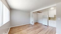 Located at 2909 Marconi Ave in the Arden-Arcade neighborhood of Sacramento, CA, this one-bedroom, one-bathroom unit offers a clean and functional layout across a single floor. Light wood-tone flooring runs throughout, lending a bright, cohesive feel to the entire space.

The open living area flows naturally into the kitchen zone, separated by a partial wall with a built-in shelving unit that provides both visual interest and additional storage. A ceiling fan overhead adds practical comfort. The kitchen is outfitted with white cabinetry, a tile backsplash, a gas range, and a full-size refrigerator, making efficient use of the available space.

The bedroom is a comfortable, well-proportioned room featuring a ceiling fan with light, a window with vertical blinds for natural light and privacy, and direct access to a dedicated closet. The neutral gray walls and wood flooring create a calm, restful atmosphere.

The bathroom features a shower-tub combination with chrome fixtures, a toilet, and a towel bar, finished with classic pink tile flooring and blue tile accents at the baseboard—adding a touch of vintage character. Overall, this unit presents a tidy, move-in-ready space with consistent finishes and practical amenities throughout.