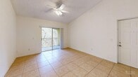 Located at 5500 NW 61st St in Coconut Creek, Florida, this 2-bedroom, 1-bathroom residence offers a well-organized single-floor layout designed for comfortable everyday living. Light-toned ceramic tile flooring runs throughout the unit, lending a clean, cohesive look to every room.

The living area is bright and open, featuring a ceiling fan with light fixture and a sliding glass door that leads to a private balcony overlooking lush, mature greenery — a peaceful outdoor retreat with natural surroundings.

The kitchen is functionally designed with ample white cabinetry reaching toward vaulted ceilings, white appliances including a range, microwave, dishwasher, and refrigerator, and a double-basin sink set into a continuous countertop. Its efficient layout makes excellent use of available space.

The spacious primary bedroom includes a ceiling fan, natural light from a large window with garden views, and a generous closet. The second bedroom also features a ceiling fan with light and a roomy closet, providing flexible usage options.

The bathroom is finished with warm beige marble-look tile on both the floors and the tub surround, complemented by a white vanity. An in-unit laundry area accommodates a full-size washer and dryer, adding day-to-day convenience to this well-appointed Coconut Creek residence.