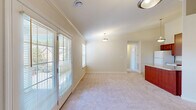 Located at 2735 Westminster Circle in Allison Park, PA, this single-floor residence offers a well-designed layout with 2 bedrooms, 2 bathrooms, and a thoughtful mix of living spaces. The bright living room features soft carpeting, crown molding, elegant pendant lighting, and French doors that open to a private balcony, filling the space with natural light and outdoor views. An additional window further enhances the airy ambiance. The kitchen is equipped with rich cherry wood cabinetry, granite-style countertops, a breakfast bar peninsula, and white appliances including a refrigerator, dishwasher, and range. Stone-look tile flooring ties the kitchen together with a clean, practical finish. The primary bedroom is generously sized, with plush carpeting and natural light filtering through large windows. The second bedroom is equally comfortable, featuring a wide window with neighborhood views. Both bathrooms are finished with stone-look tile flooring; one includes a glass-enclosed shower, while the other features a full tub-shower combo. The home also includes multiple closets for storage, a utility room, and a hallway connecting all rooms efficiently. Crown molding in the main living areas adds a refined architectural touch throughout.