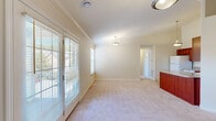 Located at 2735 Westminster Circle in Allison Park, PA, this single-floor residence offers a well-designed layout with 2 bedrooms, 2 bathrooms, and a thoughtful mix of living spaces. The bright living room features soft carpeting, crown molding, elegant pendant lighting, and French doors that open to a private balcony, filling the space with natural light and outdoor views. An additional window further enhances the airy ambiance. The kitchen is equipped with rich cherry wood cabinetry, granite-style countertops, a breakfast bar peninsula, and white appliances including a refrigerator, dishwasher, and range. Stone-look tile flooring ties the kitchen together with a clean, practical finish. The primary bedroom is generously sized, with plush carpeting and natural light filtering through large windows. The second bedroom is equally comfortable, featuring a wide window with neighborhood views. Both bathrooms are finished with stone-look tile flooring; one includes a glass-enclosed shower, while the other features a full tub-shower combo. The home also includes multiple closets for storage, a utility room, and a hallway connecting all rooms efficiently. Crown molding in the main living areas adds a refined architectural touch throughout.