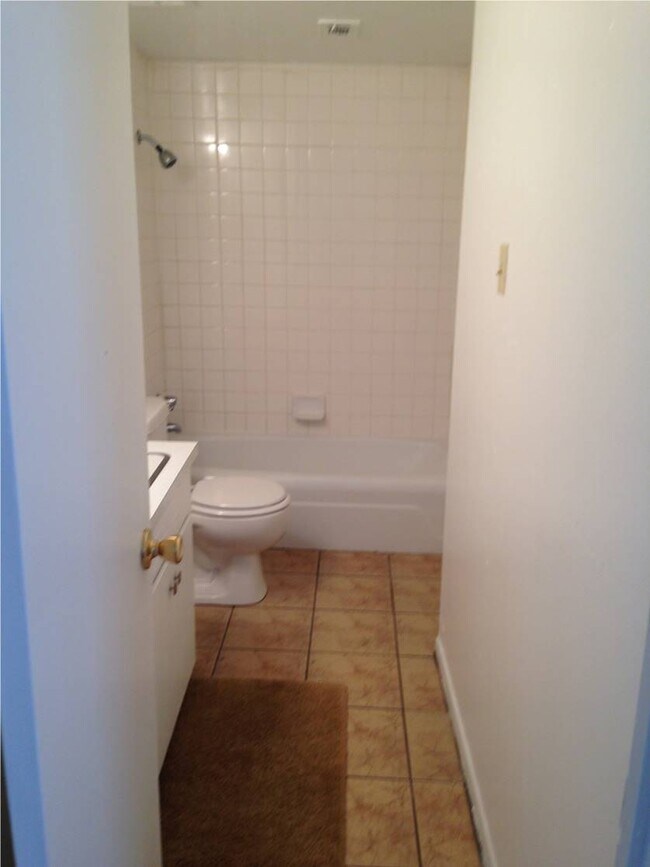 Lots of cabinet space, tiled, linen closet behind door. - 2319 Leaman Ave