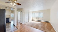 Located at 18645 Detroit Ave in Lakewood, Ohio, this single-floor unit offers a thoughtfully laid-out living space with a blend of updated finishes and functional design throughout. The living area features a combination of hardwood-style flooring and plush carpeting, a ceiling fan, and a large window dressed with vertical blinds that allows generous natural light to fill the room. A built-in wall AC unit and baseboard heating provide year-round climate control. A closet in the living area adds convenient storage. The hallway connects the living space to the rest of the unit, featuring the same hardwood-style flooring for a cohesive look. The kitchen is well-equipped with crisp white shaker-style cabinetry, granite-look countertops, a stainless steel sink, black electric range with overhead exhaust, and a dishwasher — all set on light wood-style flooring. The bedrooms are carpeted and each feature windows with vertical blinds and baseboard heating, providing a comfortable and quiet retreat. The bathroom is finished with large-format neutral tile covering the walls of the tub/shower surround, complemented by a white vanity with medicine cabinet mirror and tile flooring, delivering a clean, polished aesthetic.